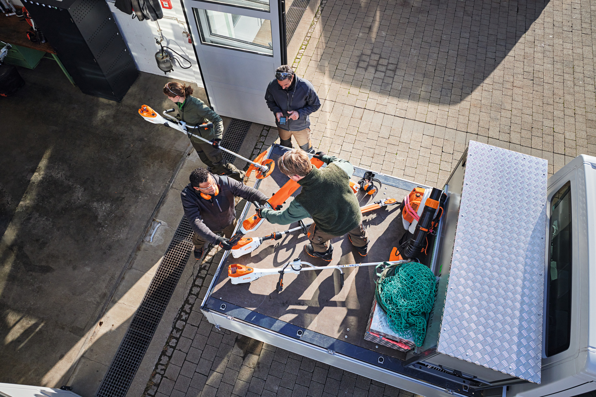 Workers unloading STIHL products from their truck