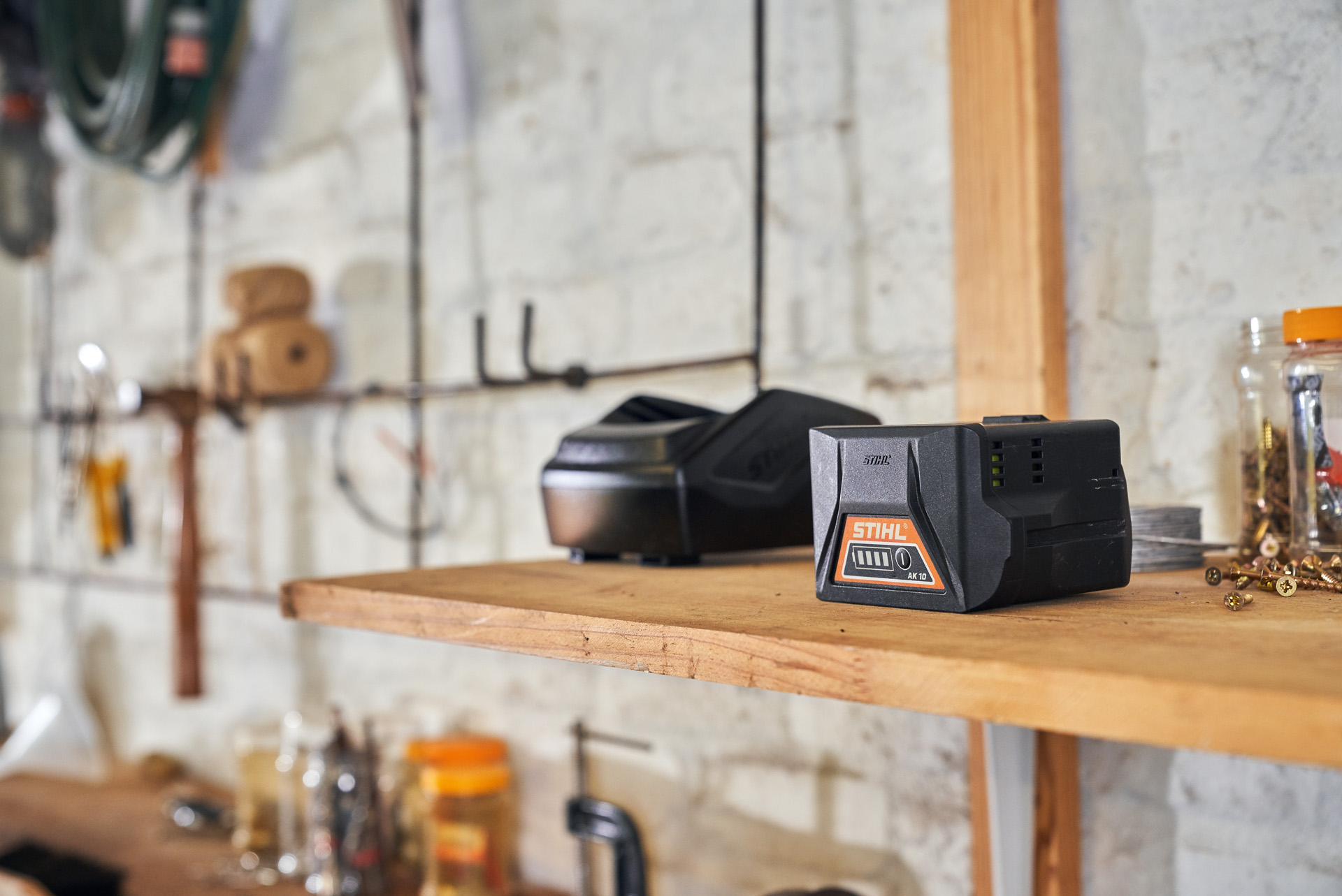 Two batteries with STIHL battery technology on a shelf in a workshop
